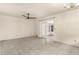 Bright and open living room with tile flooring, a ceiling fan, and sliding glass doors to a screened lanai at 2757 Pine Acres Dr, Lake Wales, FL 33898