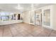 Enclosed sunroom features neutral tile floors, white walls and ceiling, and window views to the backyard at 2757 Pine Acres Dr, Lake Wales, FL 33898