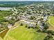 Aerial view of a residential area with lush greenery, a lake, and neatly arranged homes at 2810 Gary Ln, Lakeland, FL 33812