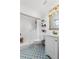 Bathroom featuring patterned tile, updated vanity, and shower with white tile surround at 2810 Gary Ln, Lakeland, FL 33812