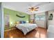 Bright and inviting bedroom with hardwood floors, serene green wall, and a comfy queen-size bed setup at 2810 Gary Ln, Lakeland, FL 33812