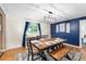 Stylish dining room highlighted by modern lighting, blue accent wall, and a wooden table with bench seating at 2810 Gary Ln, Lakeland, FL 33812