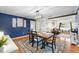 Open dining space with stylish chandelier, hardwood floors, and plenty of natural light, adjacent to the living room at 2810 Gary Ln, Lakeland, FL 33812