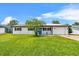 Inviting front yard with a freshly cut lawn, an attached garage, and a quaint front porch at 2810 Gary Ln, Lakeland, FL 33812