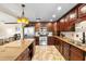 Open-concept kitchen features stainless steel appliances, granite countertops, and wood cabinetry, flowing into the connected living spaces at 2810 Gary Ln, Lakeland, FL 33812