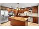 Spacious kitchen boasts stainless appliances, custom wood cabinets, tile floors and a center island with beautiful granite countertops at 2810 Gary Ln, Lakeland, FL 33812
