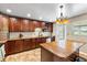 Well-equipped kitchen with stainless appliances, wood cabinets, granite counters, and a functional center island layout at 2810 Gary Ln, Lakeland, FL 33812