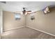 Neutral bedroom with two windows, ceiling fan, and carpet at 2920 Audie Combee Rd, Lakeland, FL 33801