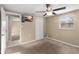 Comfortable bedroom with ceiling fan, closet, mounted TV, and view to another room at 2920 Audie Combee Rd, Lakeland, FL 33801