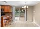Bright dining area with tile flooring, chandelier, and access to outdoor patio at 2920 Audie Combee Rd, Lakeland, FL 33801