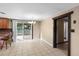 Bright dining area with tile flooring, sliding glass doors to the backyard, and an adjacent kitchen at 2920 Audie Combee Rd, Lakeland, FL 33801
