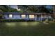 Exterior shot of the house at night with subtle lighting, showcasing its inviting curb appeal at 2920 Audie Combee Rd, Lakeland, FL 33801