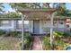 Close-up of the home's front porch entry, showing the walkway, decorative lights, and charming details at 2920 Audie Combee Rd, Lakeland, FL 33801