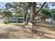Charming single-story home with mature trees, spacious front yard and covered parking at 2920 Audie Combee Rd, Lakeland, FL 33801