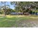 Charming single-story home featuring lush greenery, mature trees, and inviting curb appeal at 2920 Audie Combee Rd, Lakeland, FL 33801