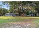 Expansive front yard view with mature trees shading the property at 2920 Audie Combee Rd, Lakeland, FL 33801