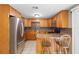 Updated kitchen featuring stainless steel appliances, tiled backsplash, and breakfast bar seating at 2920 Audie Combee Rd, Lakeland, FL 33801