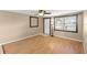 Cozy living room with wood laminate floors, ceiling fan, and natural light at 2920 Audie Combee Rd, Lakeland, FL 33801