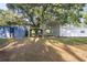 Large yard features multiple carports and storage sheds at 2920 Audie Combee Rd, Lakeland, FL 33801