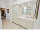A spacious bathroom features ample counter space, storage cabinets, and tile floors, creating a clean and organized space at 2936 Grasslands Dr, Lakeland, FL 33803
