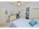 Cozy bedroom featuring a white dresser with mirror, built-in shelving, and a tranquil atmosphere at 2936 Grasslands Dr, Lakeland, FL 33803