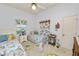 Bright bedroom with two twin beds, overhead fan, floral accents, and decor at 2936 Grasslands Dr, Lakeland, FL 33803