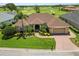 Beautiful home with mature landscaping, brick driveway, and golf course views at 2936 Grasslands Dr, Lakeland, FL 33803