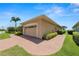 Spacious two-car garage with brick driveway and manicured landscaping at 2936 Grasslands Dr, Lakeland, FL 33803