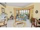 Bright living room with golf course view, floral accents, and screened patio access at 2936 Grasslands Dr, Lakeland, FL 33803