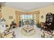 Comfortable living room with floral accents, golf course views, and screened patio access at 2936 Grasslands Dr, Lakeland, FL 33803