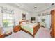 Inviting main bedroom with tray ceiling, a decorative ceiling fan, matching nightstands, and ensuite bathroom at 2936 Grasslands Dr, Lakeland, FL 33803