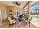 Inviting covered patio features comfortable seating, perfect for outdoor relaxation by the pool at 2936 Grasslands Dr, Lakeland, FL 33803