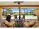 Expansive covered patio with seating and a serene view of the pool and golf course at 2936 Grasslands Dr, Lakeland, FL 33803