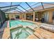 The screened-in pool and spa are surrounded by ample patio space, perfect for entertaining and enjoying the Florida sunshine at 2936 Grasslands Dr, Lakeland, FL 33803