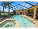 A beautiful screened-in pool and spa with a spacious deck and tropical landscaping provide a relaxing outdoor oasis at 2936 Grasslands Dr, Lakeland, FL 33803