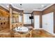 Luxurious bathroom featuring a jacuzzi tub, elegant chandelier, and a walk-in shower with tile accents at 3020 Crews Lake Dr, Lakeland, FL 33813