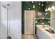The bathroom has a shower and vanity area with green walls and decorative accents at 3020 Crews Lake Dr, Lakeland, FL 33813