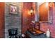 Striking powder room with stone accent wall, decorative mirror, and vessel sink at 3020 Crews Lake Dr, Lakeland, FL 33813