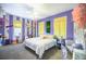 A whimsically decorated bedroom in pastel purples with vibrant yellow accents and playful decor at 3020 Crews Lake Dr, Lakeland, FL 33813