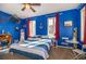 Nautical-themed bedroom featuring a blue color scheme, decorative anchor, and a cozy striped bed at 3020 Crews Lake Dr, Lakeland, FL 33813