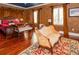 Spacious bedroom with hardwood floors, a comfortable sitting area, and luxurious decor at 3020 Crews Lake Dr, Lakeland, FL 33813
