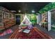 Whimsical bonus room with a teepee, wood accents, and playful decor, creating a unique and inviting space at 3020 Crews Lake Dr, Lakeland, FL 33813