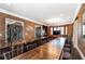 Large dining room with wood flooring and walls painted with a dark finish, featuring many tables and chairs at 3020 Crews Lake Dr, Lakeland, FL 33813