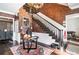 Inviting foyer with staircase, table and decor, chandelier, dark hardwood floors, and textured walls at 3020 Crews Lake Dr, Lakeland, FL 33813