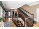 A grand foyer with elegant staircase and beautiful wood and tile flooring at 3020 Crews Lake Dr, Lakeland, FL 33813