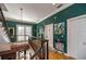 Bright upper hallway with green walls, elegant railings, and tile flooring at 3020 Crews Lake Dr, Lakeland, FL 33813