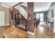 Spacious upstairs hallway featuring staircase, elegant railing, and tile flooring at 3020 Crews Lake Dr, Lakeland, FL 33813