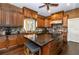 Well-appointed kitchen featuring custom cabinets, granite countertops, and a center island with seating at 3020 Crews Lake Dr, Lakeland, FL 33813