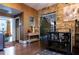 Transitional living space featuring modern decor with brick wall features and hardwood floors at 3020 Crews Lake Dr, Lakeland, FL 33813