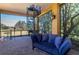 Patio with a spiral staircase, comfortable sofa, and views of the surrounding landscape at 3020 Crews Lake Dr, Lakeland, FL 33813